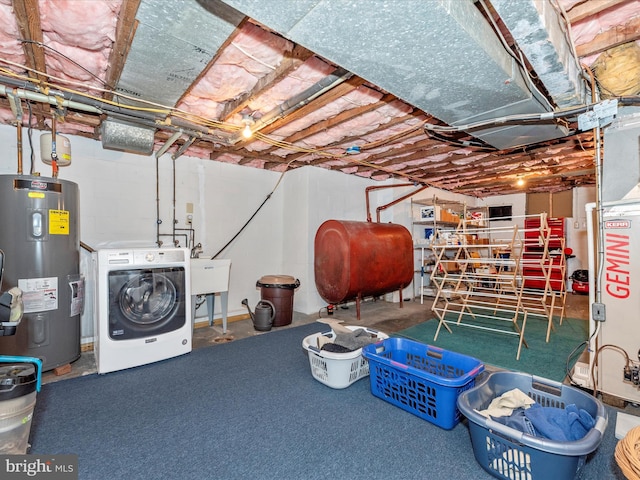 unfinished basement with washer / clothes dryer, a sink, electric water heater, and heating fuel