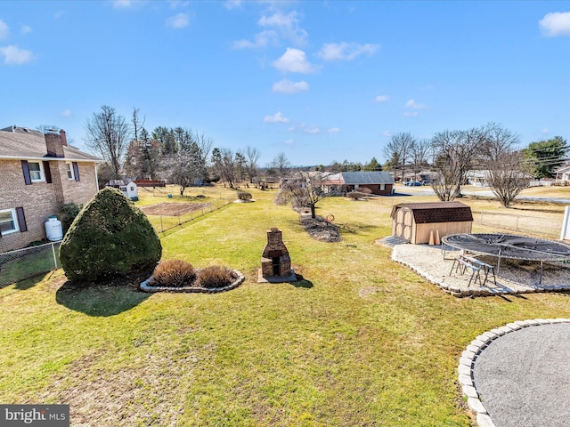 view of yard with fence and an outdoor structure