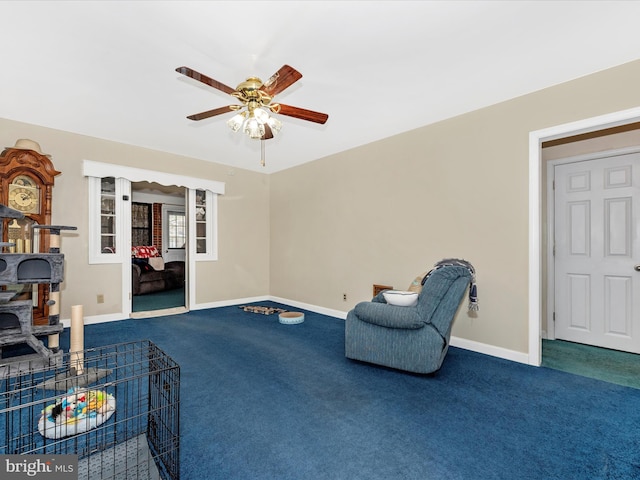 living area featuring a ceiling fan, carpet, and baseboards