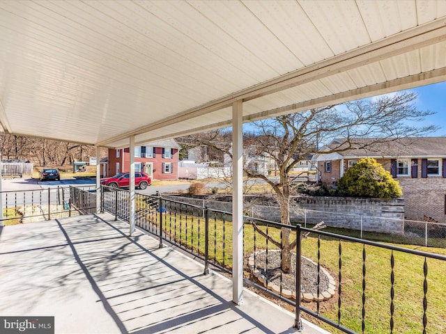 view of patio with a residential view and fence