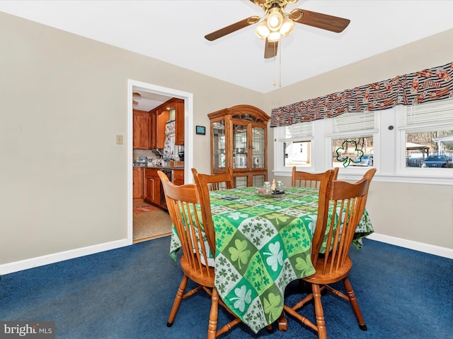 dining area featuring ceiling fan, carpet, and baseboards