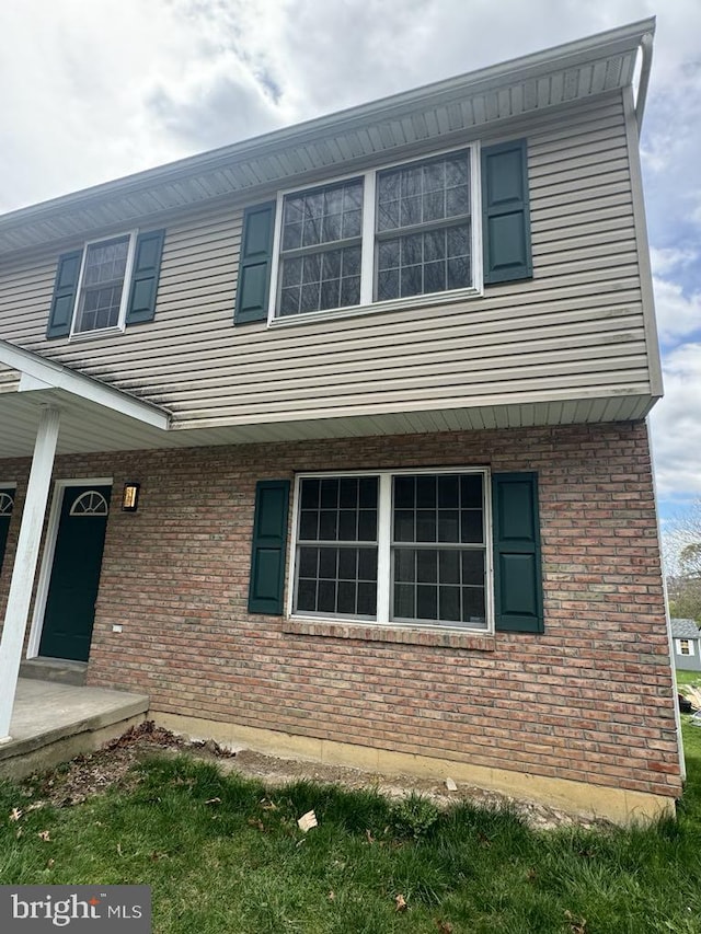 view of property exterior with brick siding