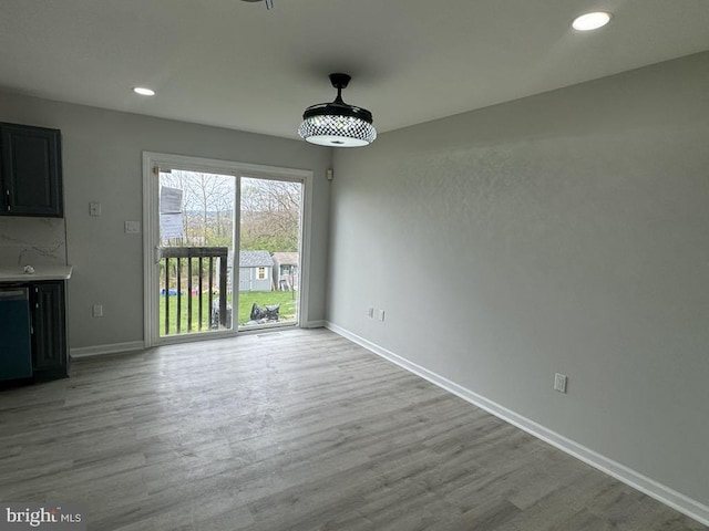 unfurnished dining area with recessed lighting, wood finished floors, and baseboards