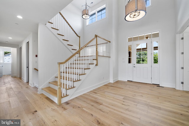 entrance foyer with recessed lighting, baseboards, and wood finished floors