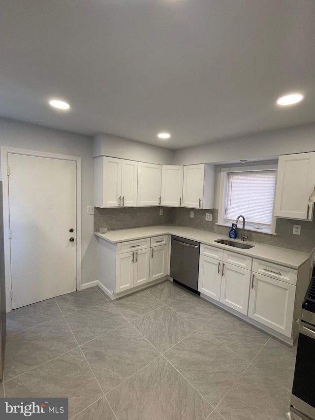 kitchen with white cabinets, a sink, and stainless steel dishwasher