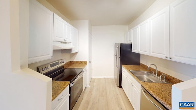 kitchen featuring stainless steel appliances, white cabinets, a sink, and under cabinet range hood