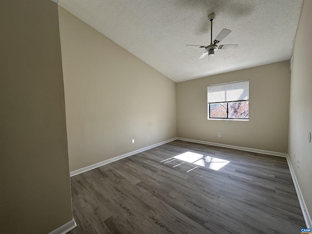 spare room featuring dark wood-style floors, a textured ceiling, baseboards, and a ceiling fan