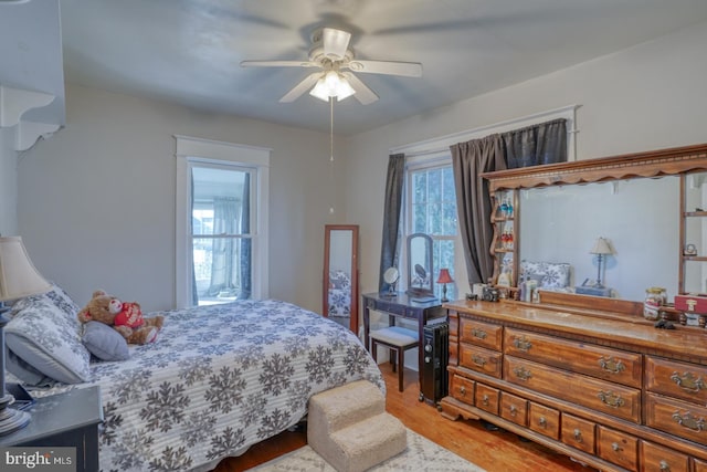 bedroom featuring a ceiling fan and light wood-style floors