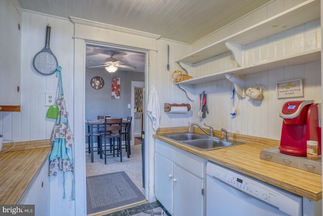 kitchen featuring light countertops, white dishwasher, a sink, and open shelves