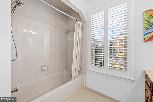 bathroom with baseboards, shower / bath combo with shower curtain, vanity, and tile patterned floors