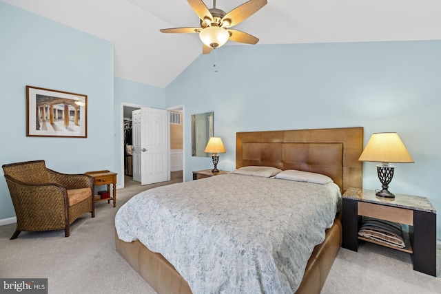 bedroom with light colored carpet, ceiling fan, a spacious closet, high vaulted ceiling, and a closet