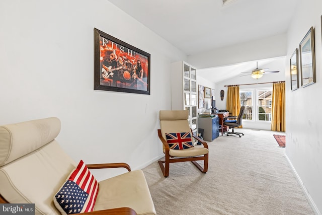 living area with vaulted ceiling, carpet flooring, a ceiling fan, and baseboards