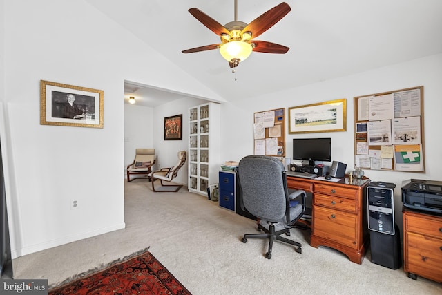 office area featuring vaulted ceiling, ceiling fan, light carpet, and baseboards