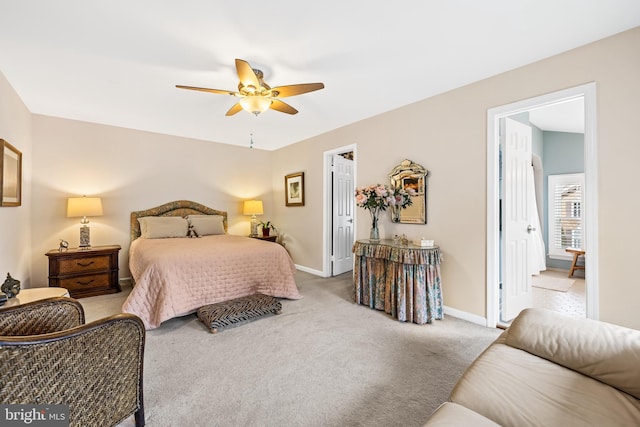 carpeted bedroom with baseboards and a ceiling fan