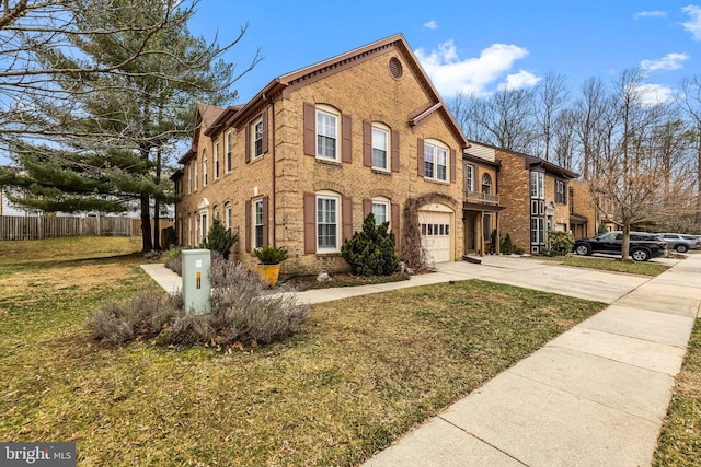 view of front of home with an attached garage, brick siding, fence, concrete driveway, and a front yard