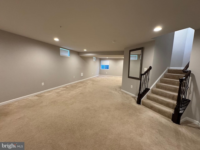 basement featuring carpet, baseboards, and recessed lighting