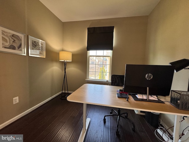 home office featuring baseboards and dark wood finished floors