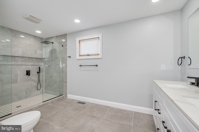 bathroom with baseboards, a tile shower, toilet, and tile patterned floors