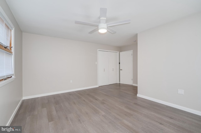 empty room featuring baseboards and wood finished floors