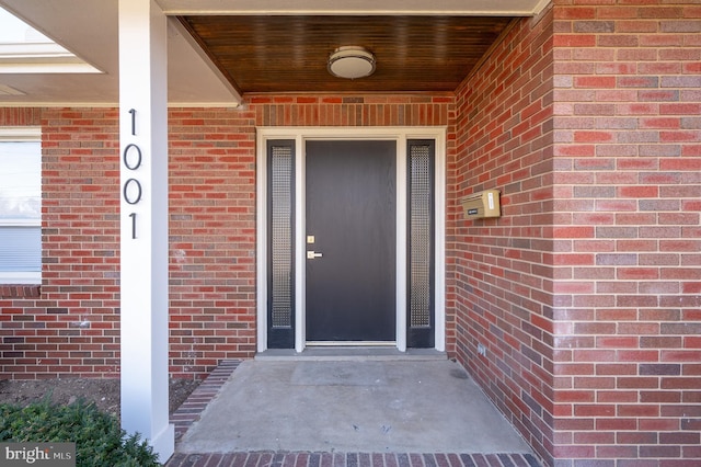 property entrance with brick siding