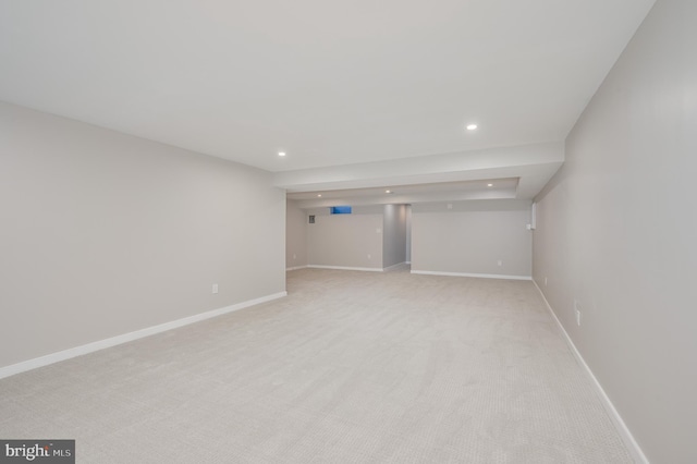 spare room with recessed lighting, light colored carpet, and baseboards