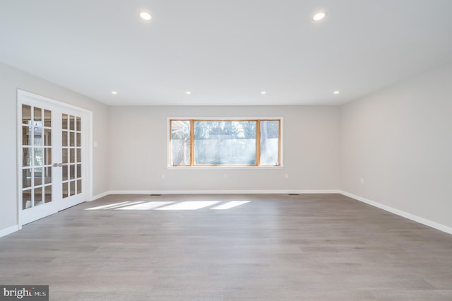 empty room with wood finished floors and recessed lighting