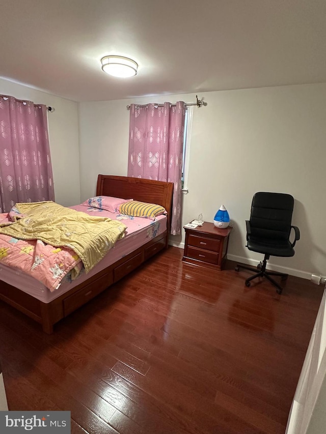 bedroom featuring baseboards and wood finished floors