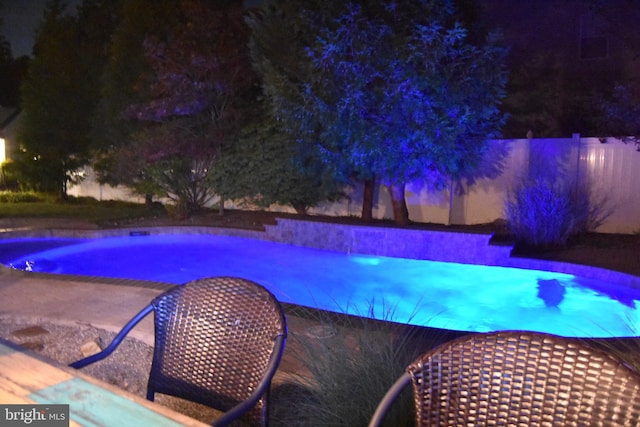 view of swimming pool featuring fence and a fenced in pool