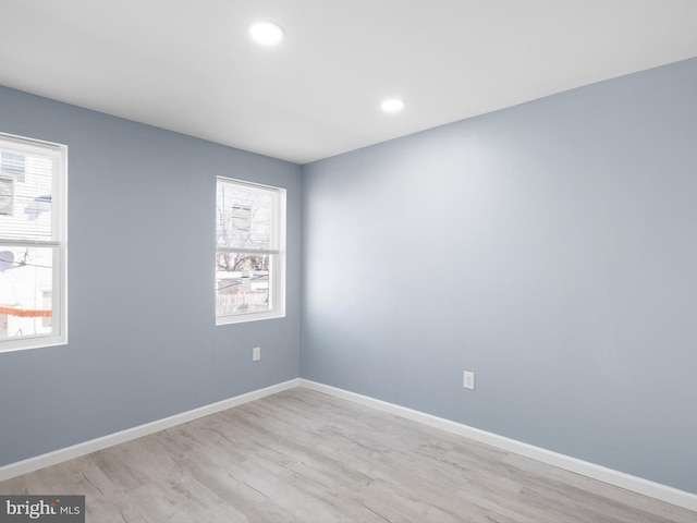 unfurnished room with recessed lighting, light wood-style flooring, and baseboards