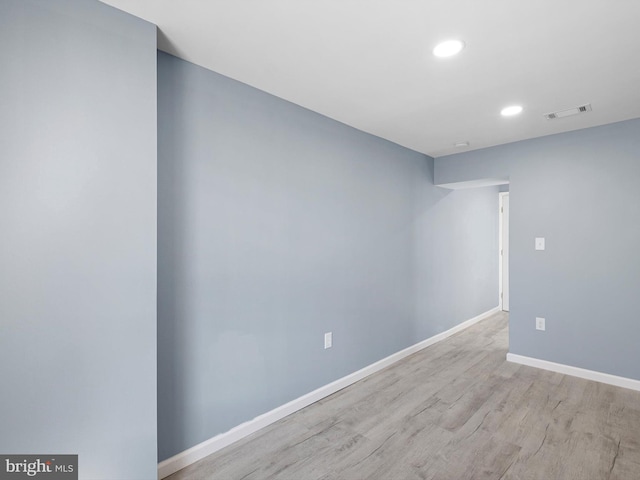 empty room with recessed lighting, visible vents, baseboards, and wood finished floors