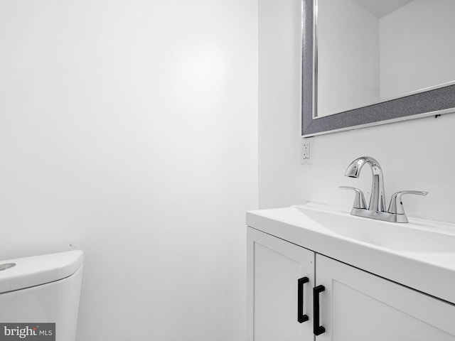 half bath with vanity and toilet