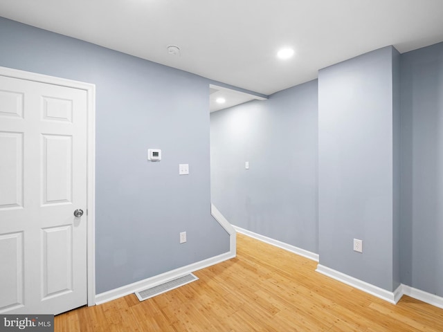 empty room featuring recessed lighting, light wood-type flooring, visible vents, and baseboards