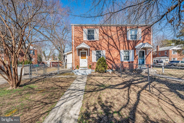 view of front facade with a gate, brick siding, and fence