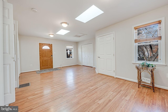 foyer featuring plenty of natural light, visible vents, and light wood-style floors