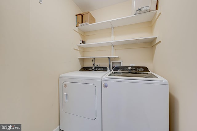 washroom featuring laundry area and washer and clothes dryer