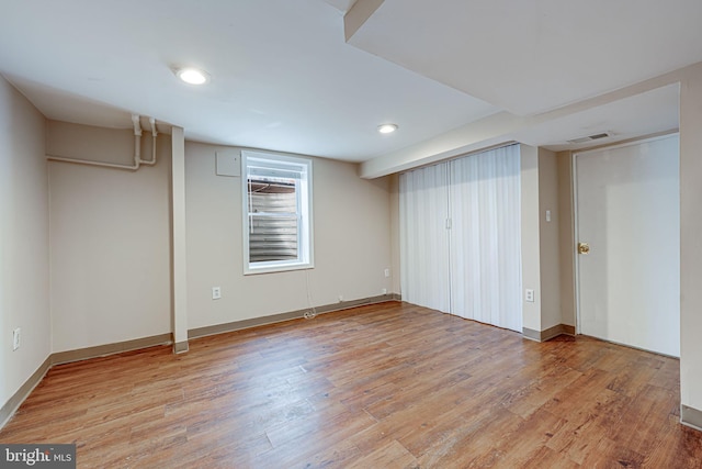 basement featuring baseboards, recessed lighting, visible vents, and light wood-style floors