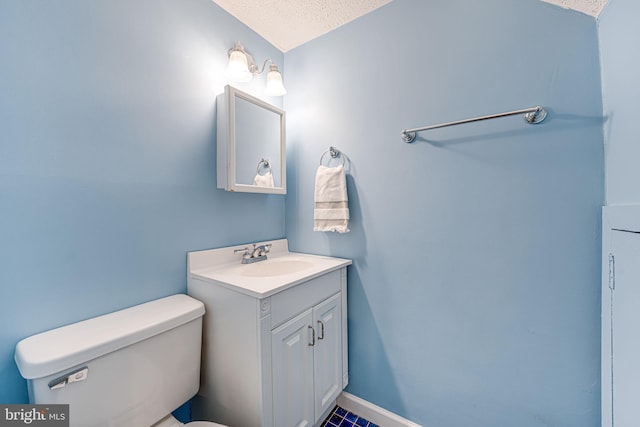 half bath featuring toilet, a textured ceiling, and vanity