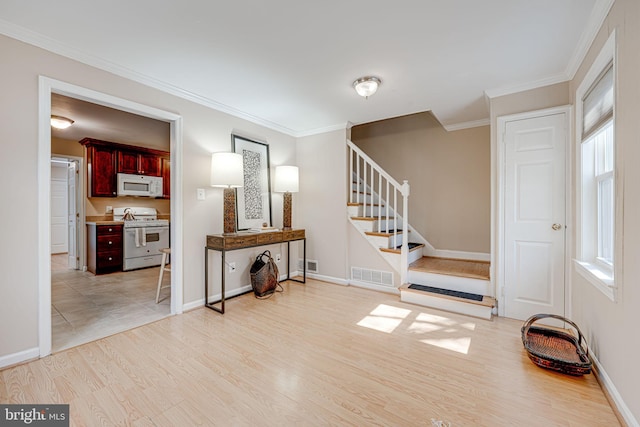 entrance foyer featuring visible vents, stairway, and light wood finished floors