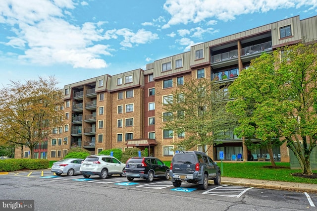 view of building exterior with uncovered parking