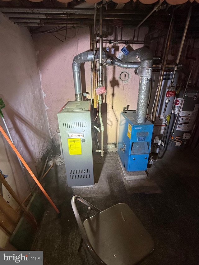 utility room featuring water heater