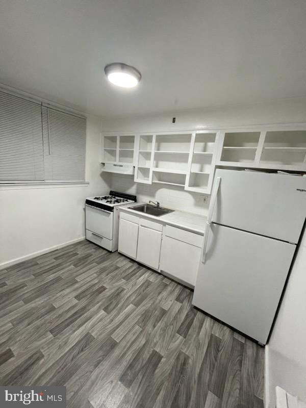 kitchen with under cabinet range hood, white appliances, a sink, white cabinets, and open shelves