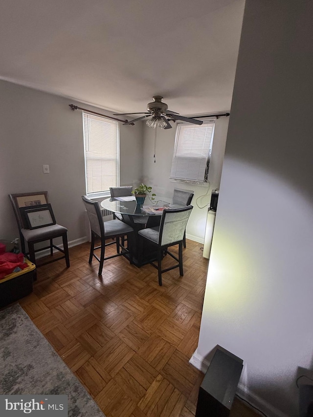 dining area featuring baseboards and a ceiling fan