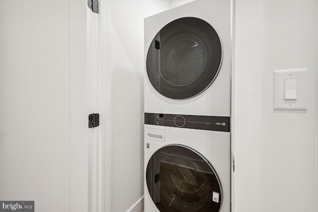 laundry area with stacked washing maching and dryer