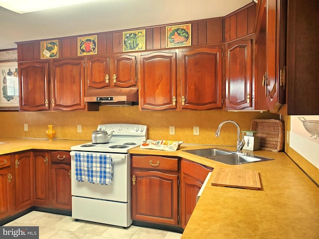 kitchen featuring white electric stove, light countertops, a sink, and under cabinet range hood