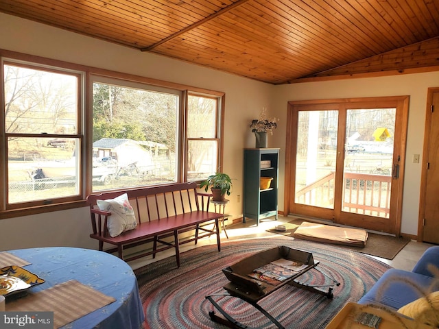 sunroom featuring wood ceiling, a healthy amount of sunlight, and vaulted ceiling