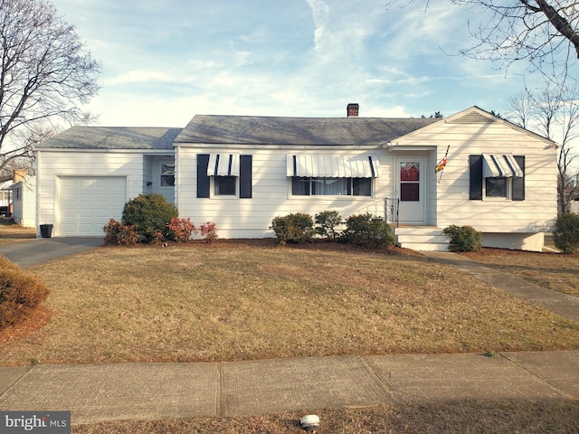 ranch-style house with a front yard, driveway, a chimney, and an attached garage