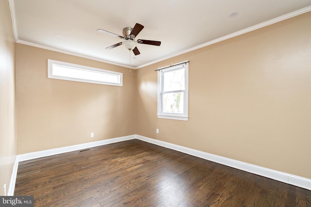 unfurnished room featuring dark wood-style floors, baseboards, and crown molding