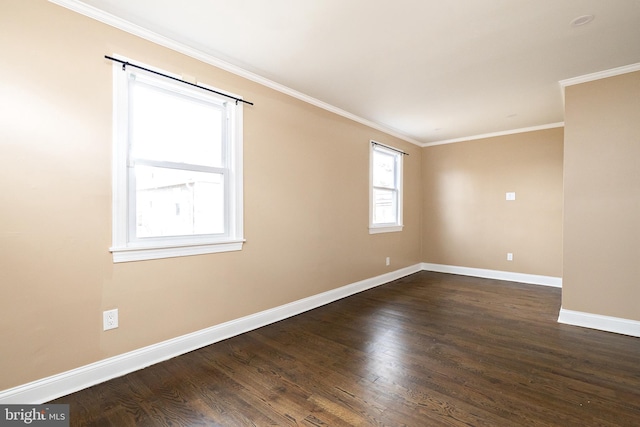 spare room with baseboards, dark wood-type flooring, and crown molding