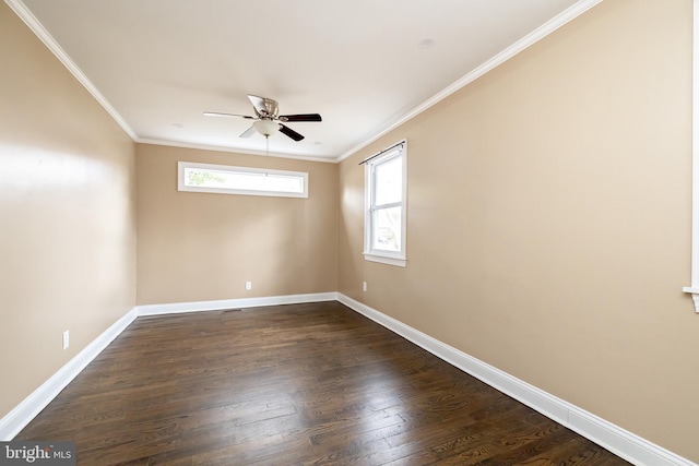 empty room with dark wood-style floors, ceiling fan, ornamental molding, and baseboards