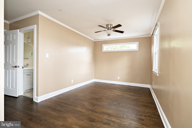 unfurnished room featuring ornamental molding, dark wood finished floors, and baseboards